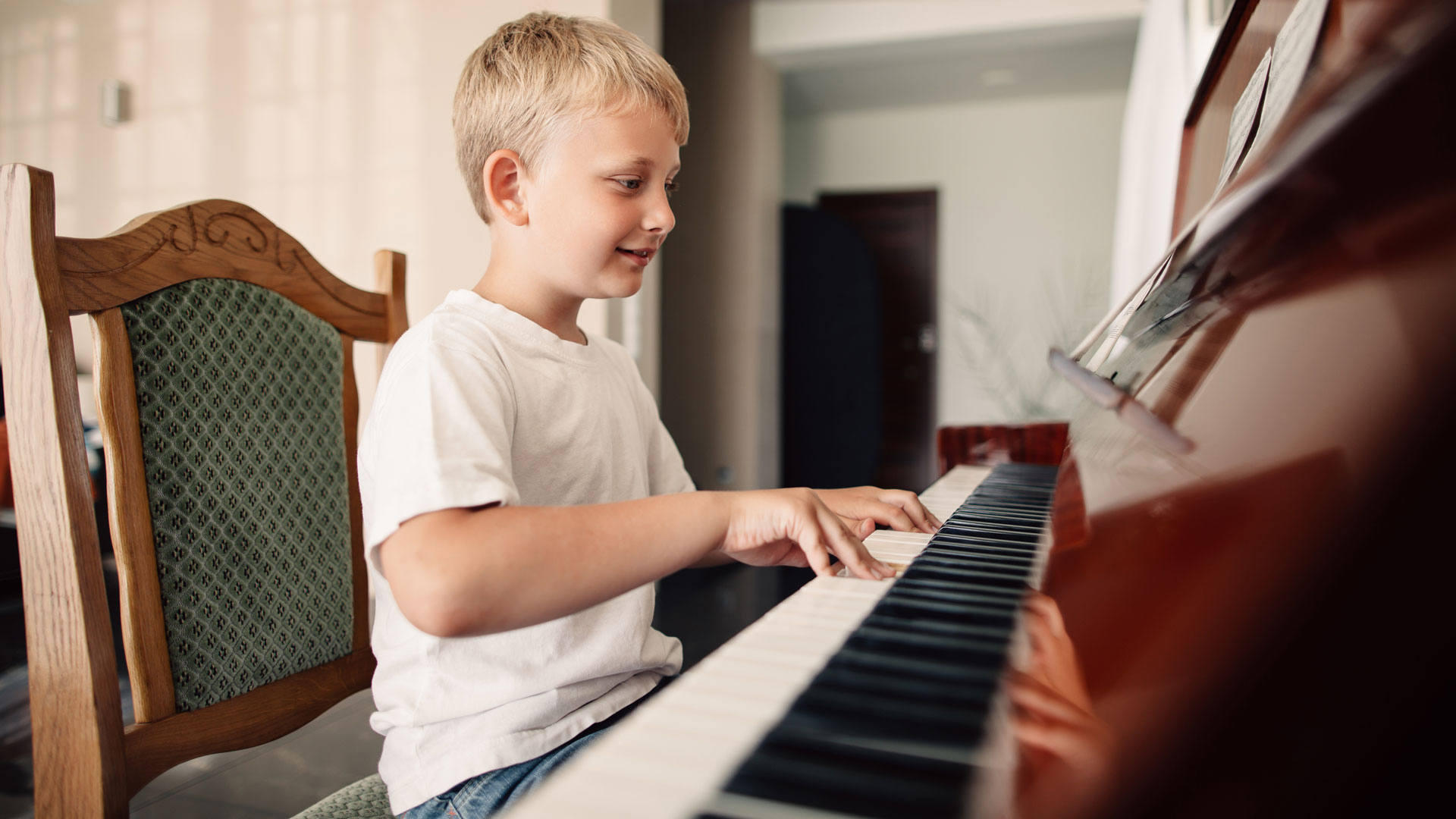 blonde boy playing piano