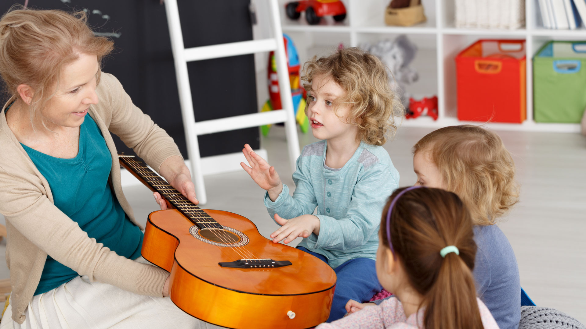children learning how to play guitar
