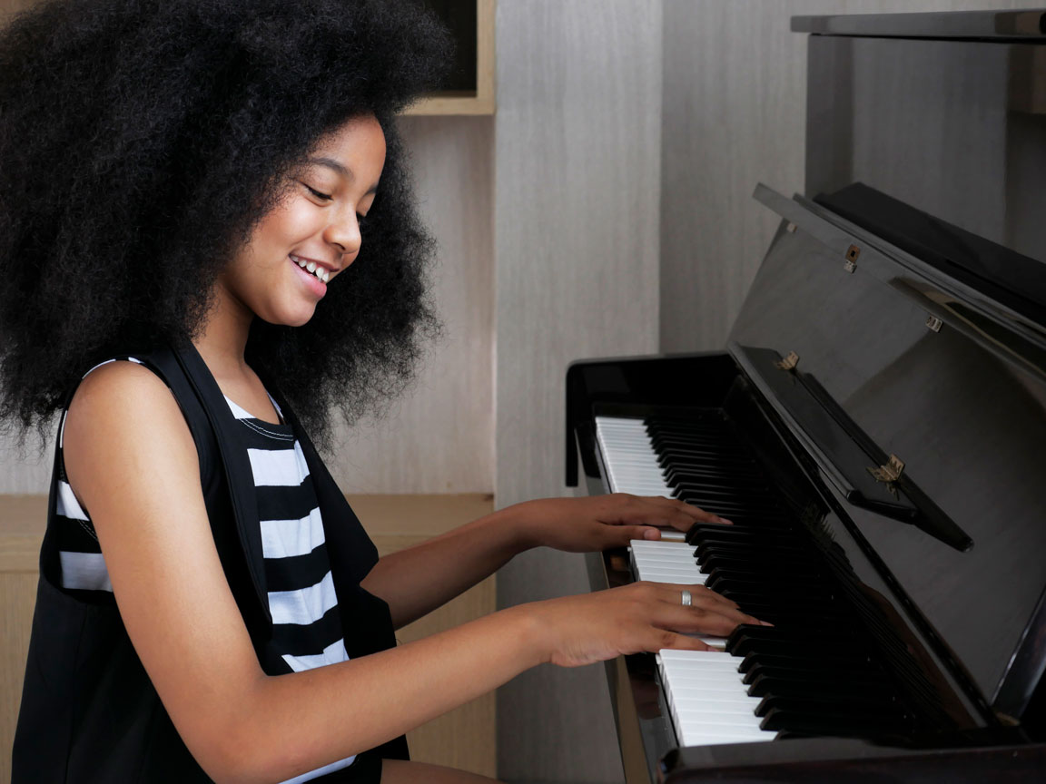 young African American girl playing piano